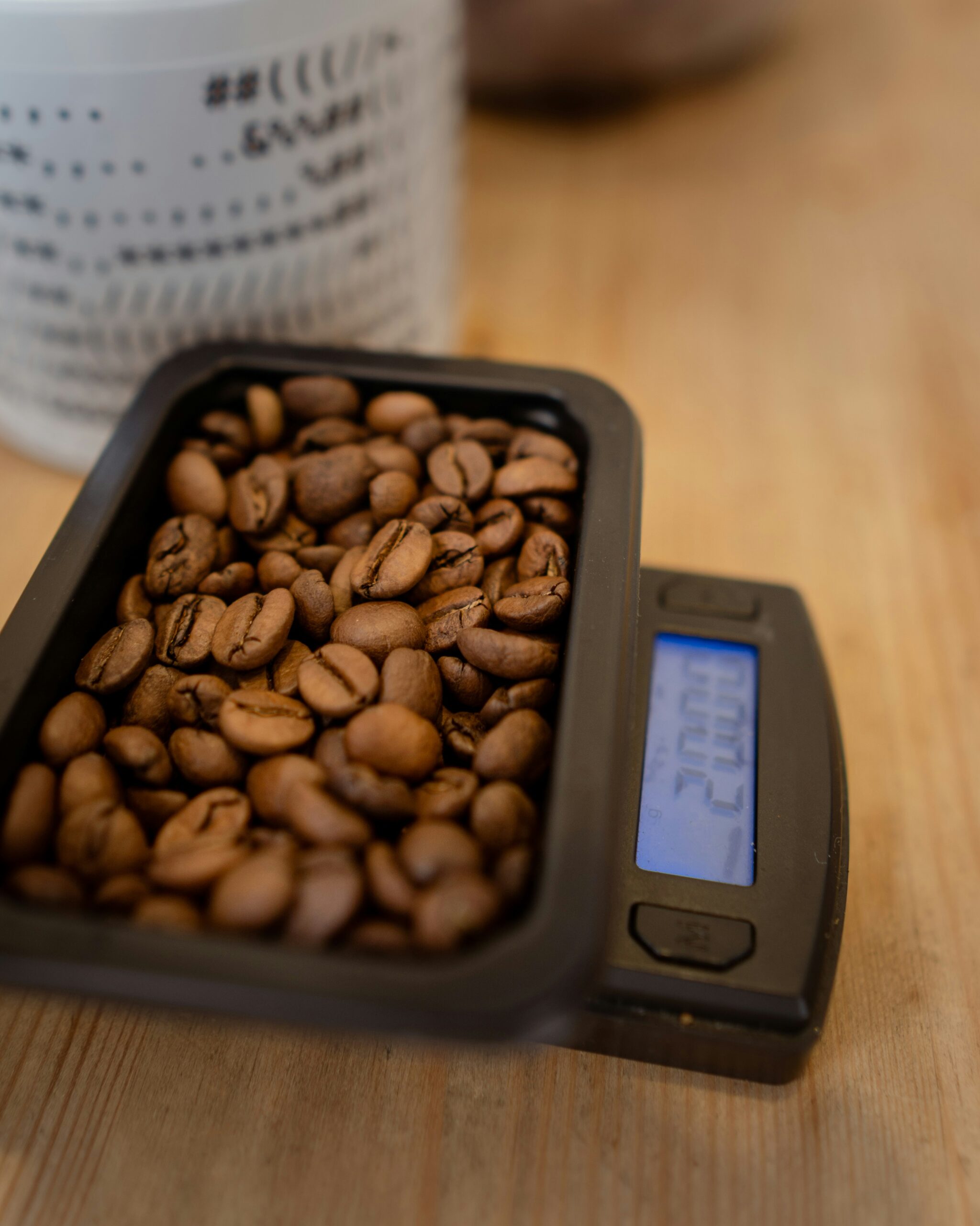 Healthy lifestyle concept image showing coffee beans and measuring tape on white background