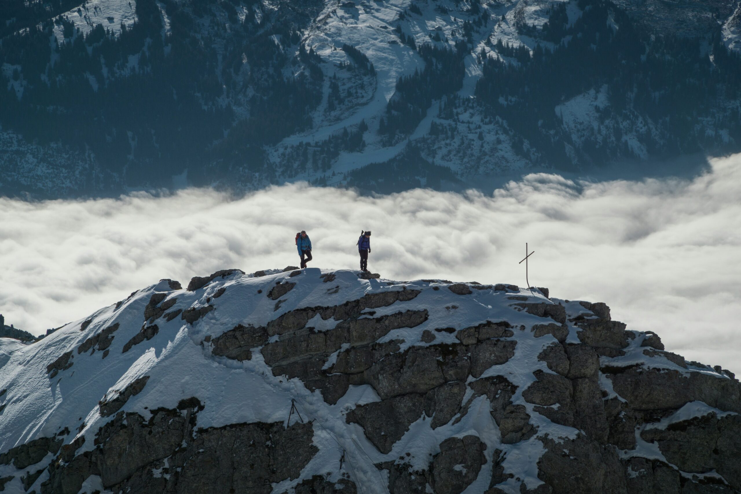 Happy active senior couple hiking in the Swiss Alps, looking energized and healthy.