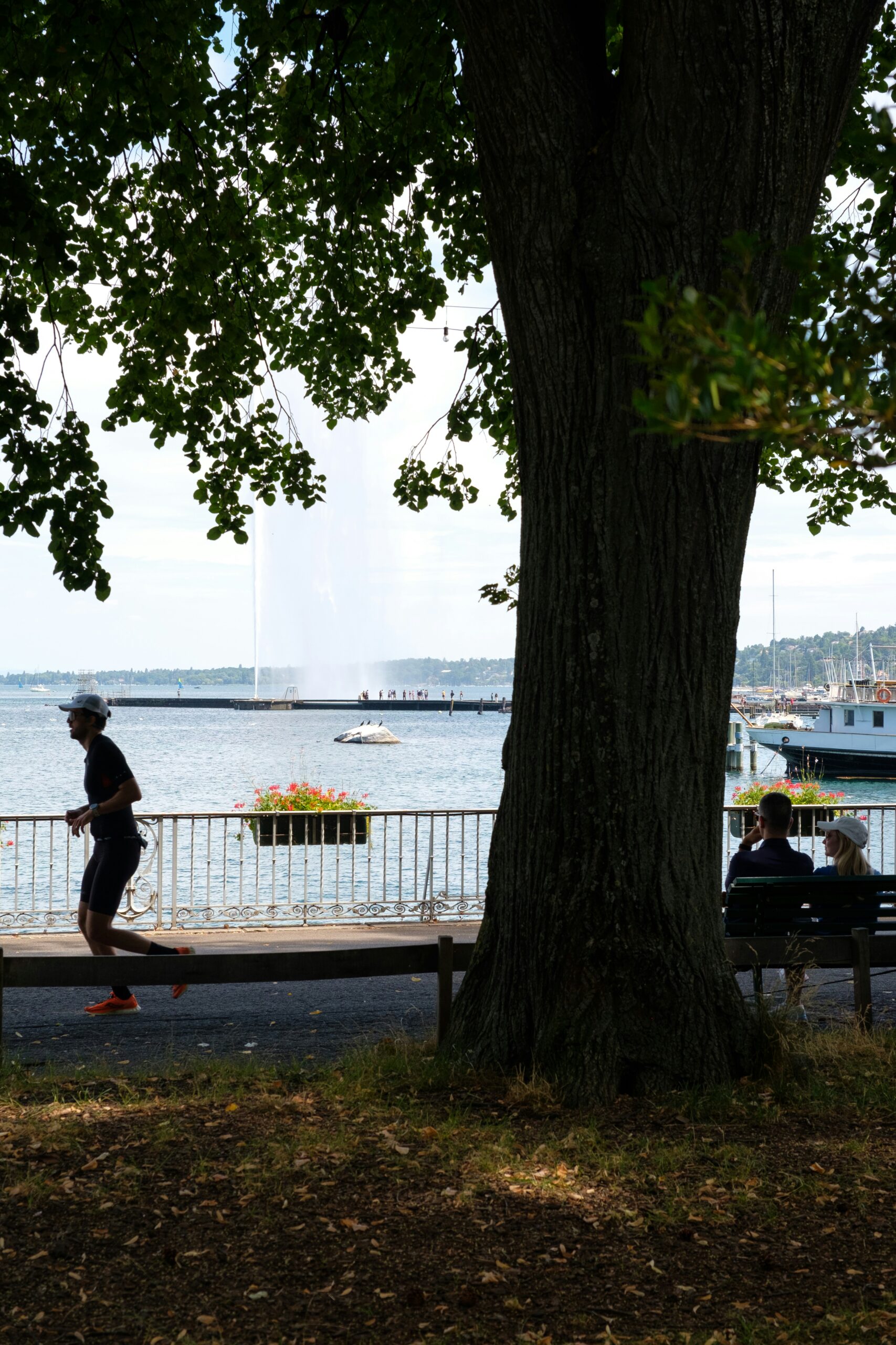 Fit woman jogging near Lake Geneva or a Swiss landscape, representing healthy active lifestyle.