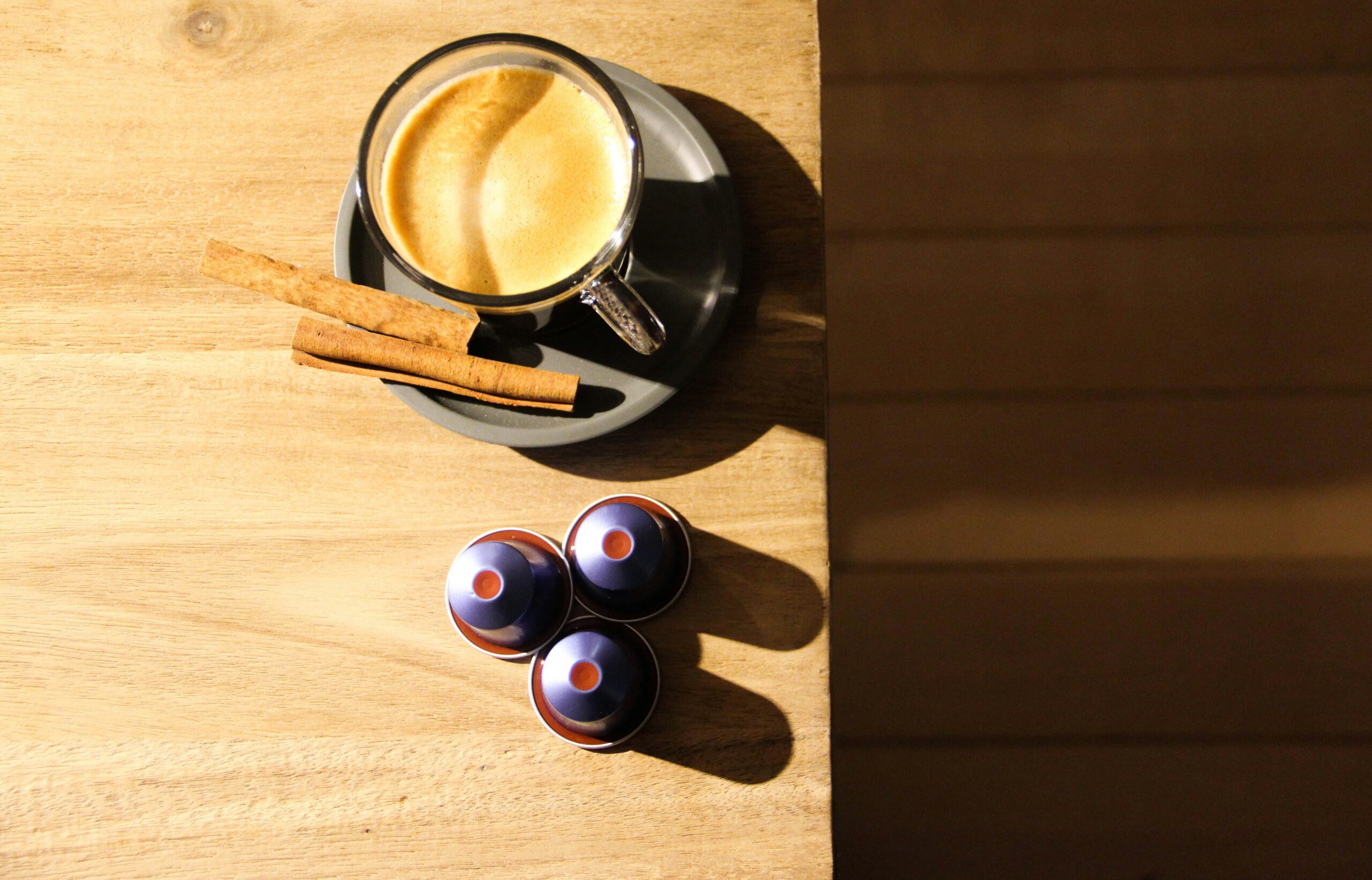 flat lay photography of coffee beans and marita product cans on a wooden table
