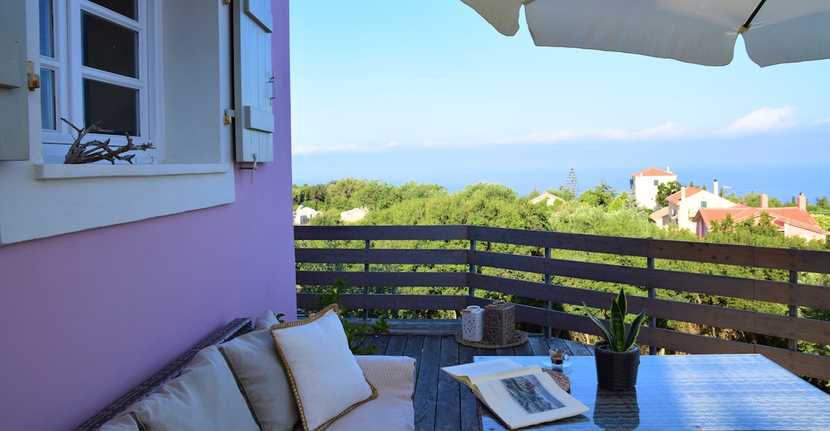 a balcony with a table and chairs