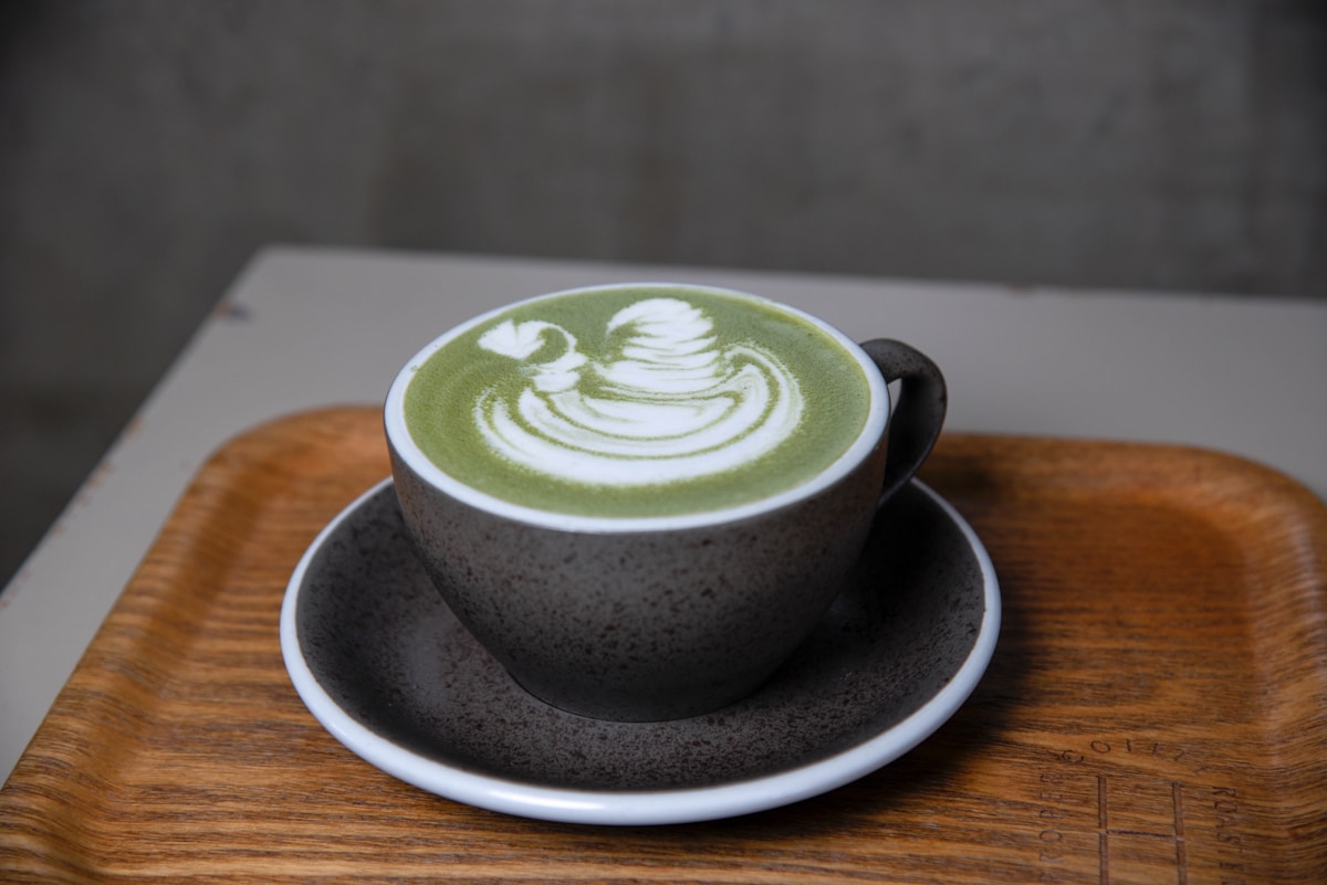 a cup of green tea on a saucer