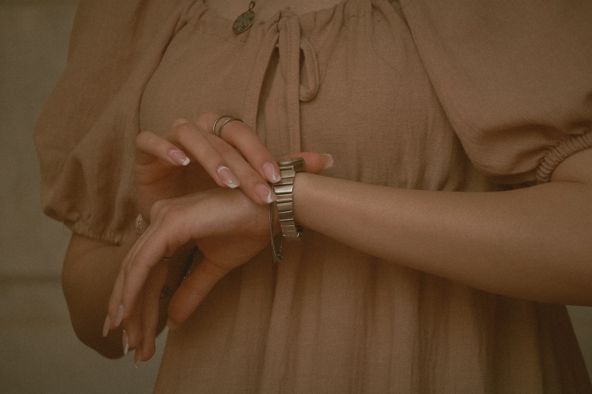 A woman checks her watch.