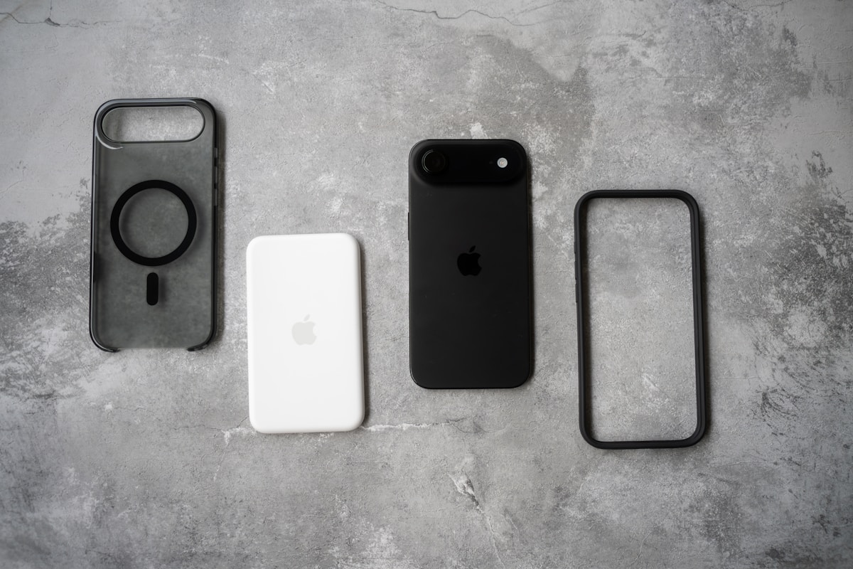 Four smartphone accessories arranged on a textured surface.